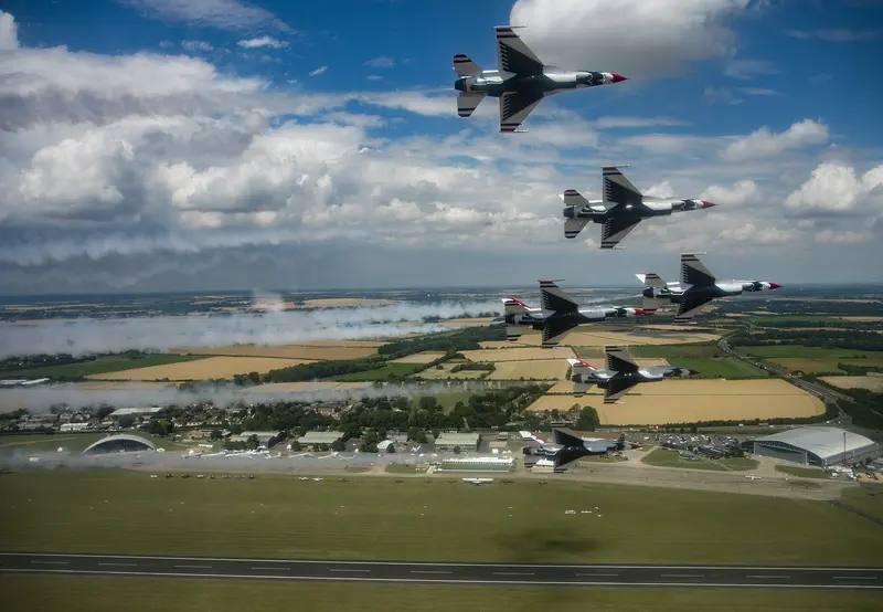Six USAF Thunderbirds F-16s in formation over the airfield at Duxford, Cambridgeshire